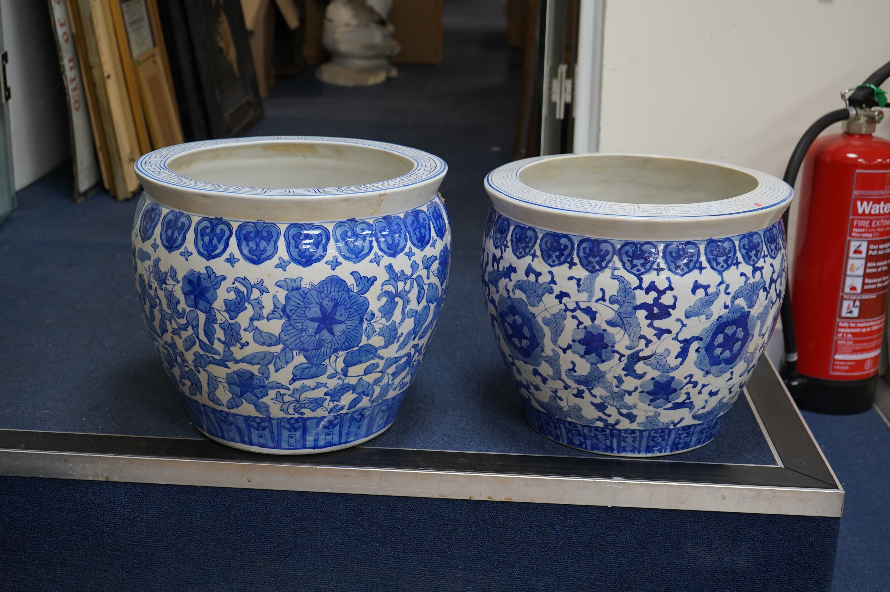 Two Chinese blue and white jardinieres, 31cm high. Condition - fair